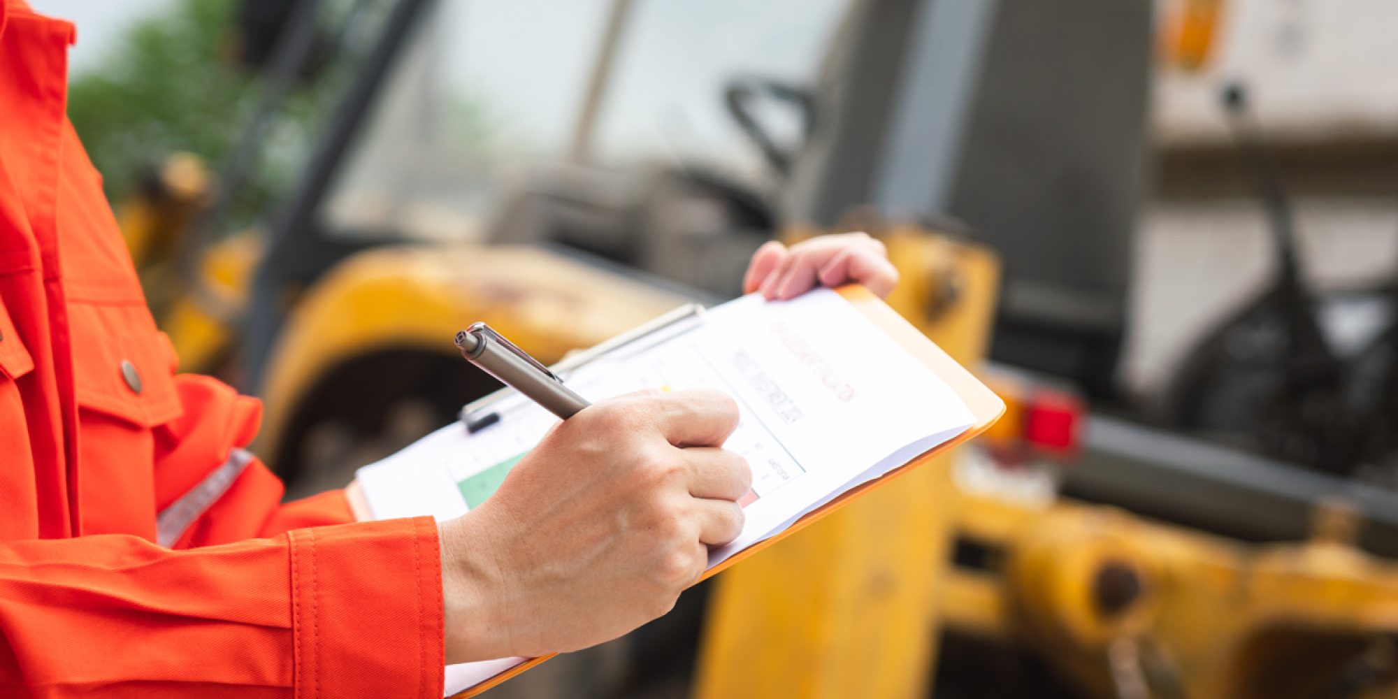 A person going over paperwork at a construction site in Las Cruces.