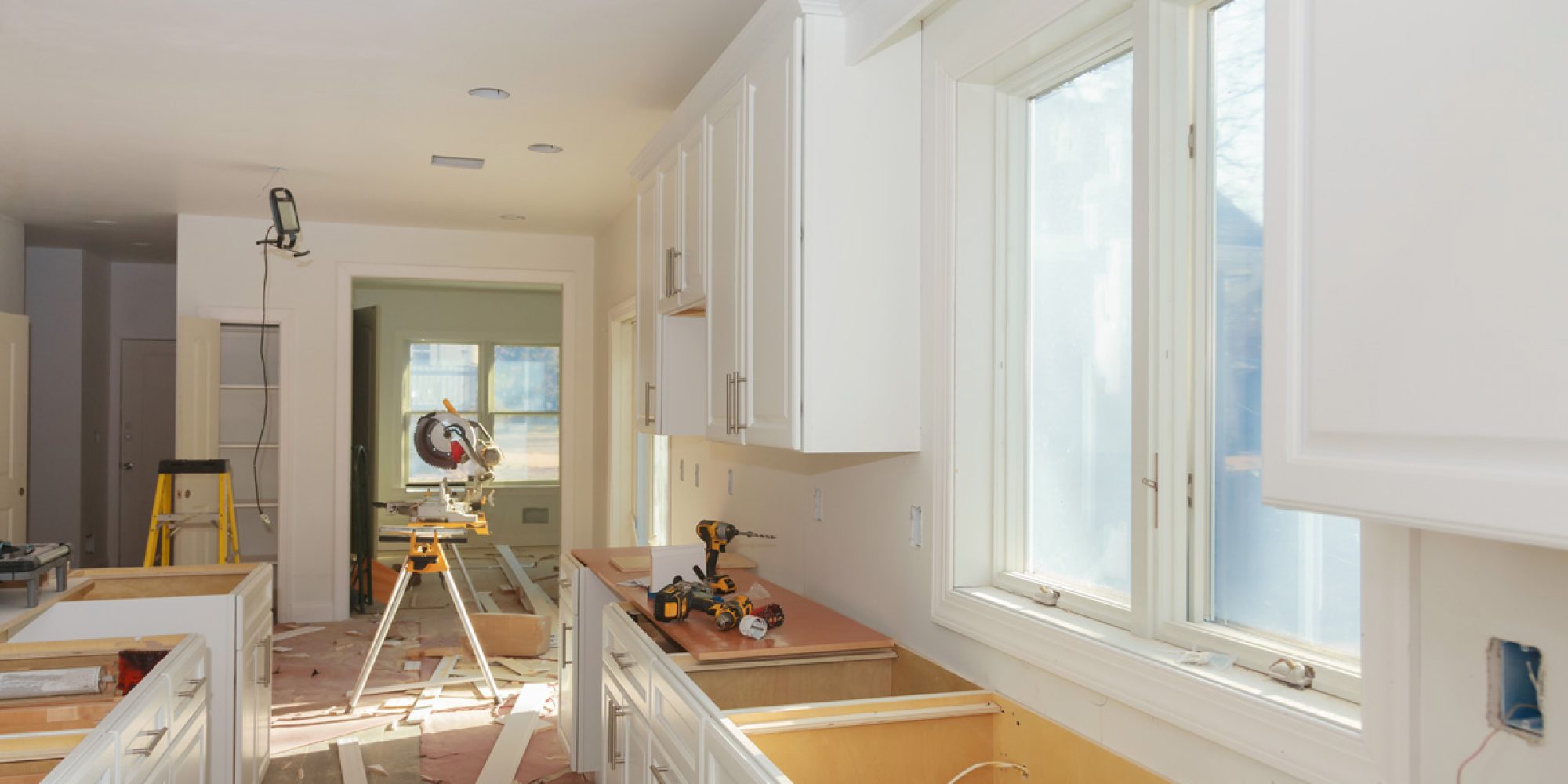A kitchen with white cabinets undergoing a remodel in Las Cruces.