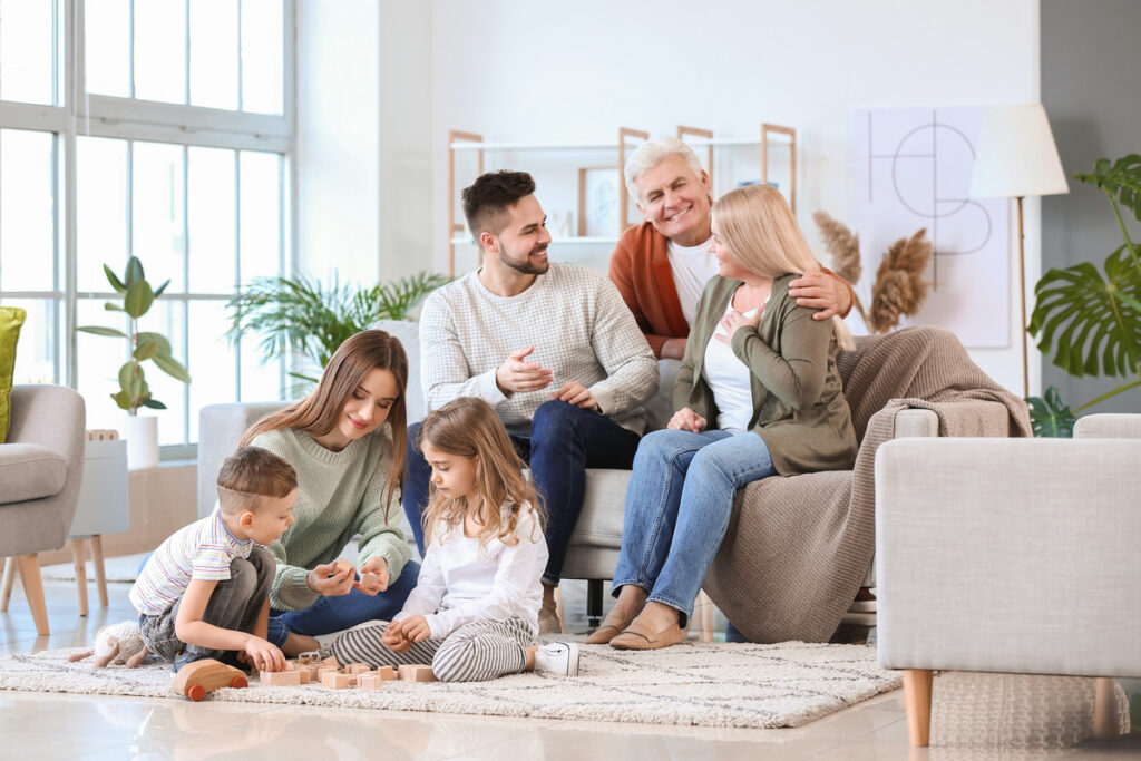 A family sitting on a couch in a Las Cruces home.