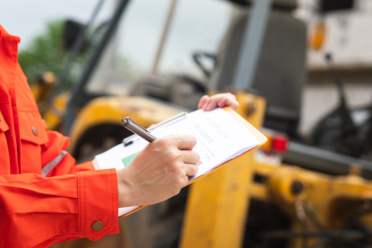 A person going over paperwork at a construction site in Las Cruces.