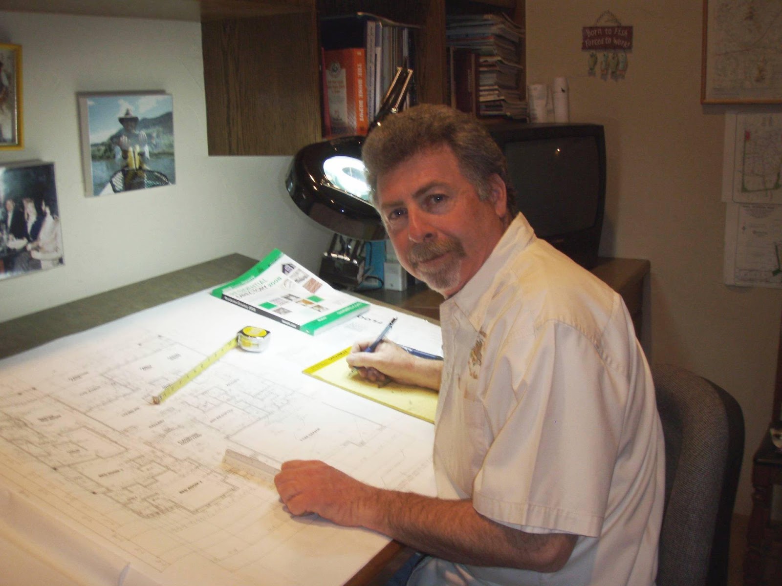 Judd Singer sitting at his drafting desk, working on a new floor plan